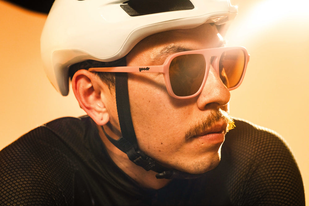 Goodr Retro G sunglasses Threaten Me With a Good Time featuring light pink vintage-inspired square aviator frames with brown non-reflective lenses, designed to stay secure without slipping or bouncing