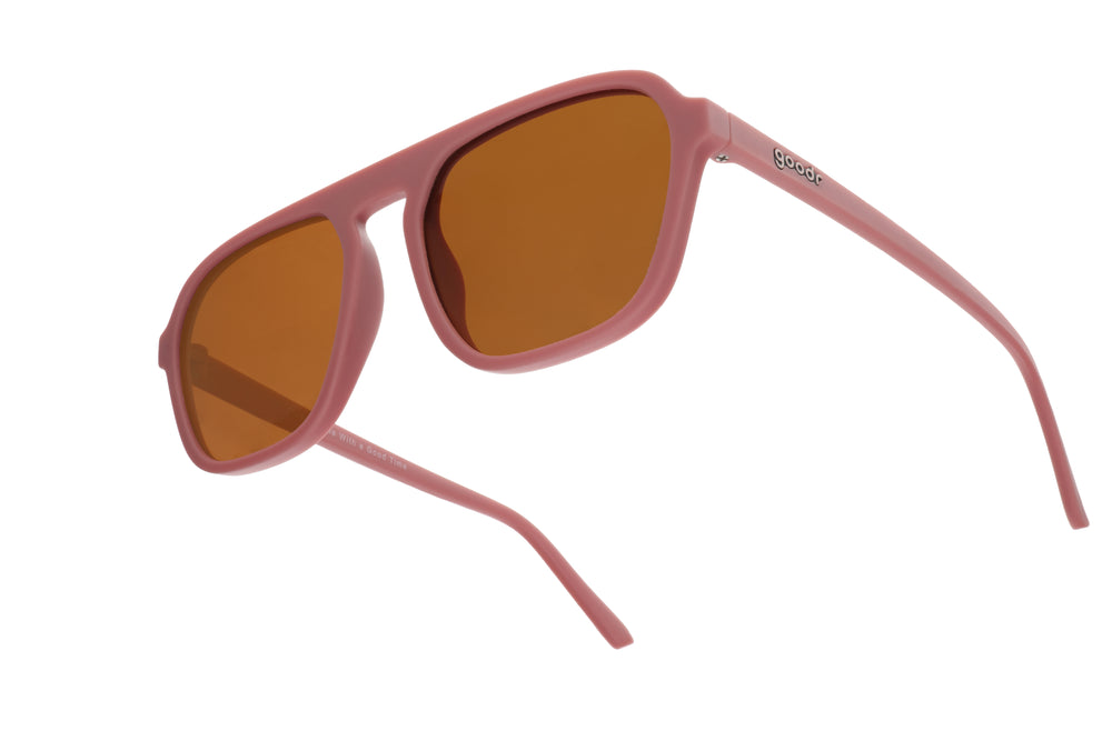 Goodr Retro G sunglasses Threaten Me With a Good Time featuring light pink vintage-inspired square aviator frames with brown non-reflective lenses, designed to stay secure without slipping or bouncing