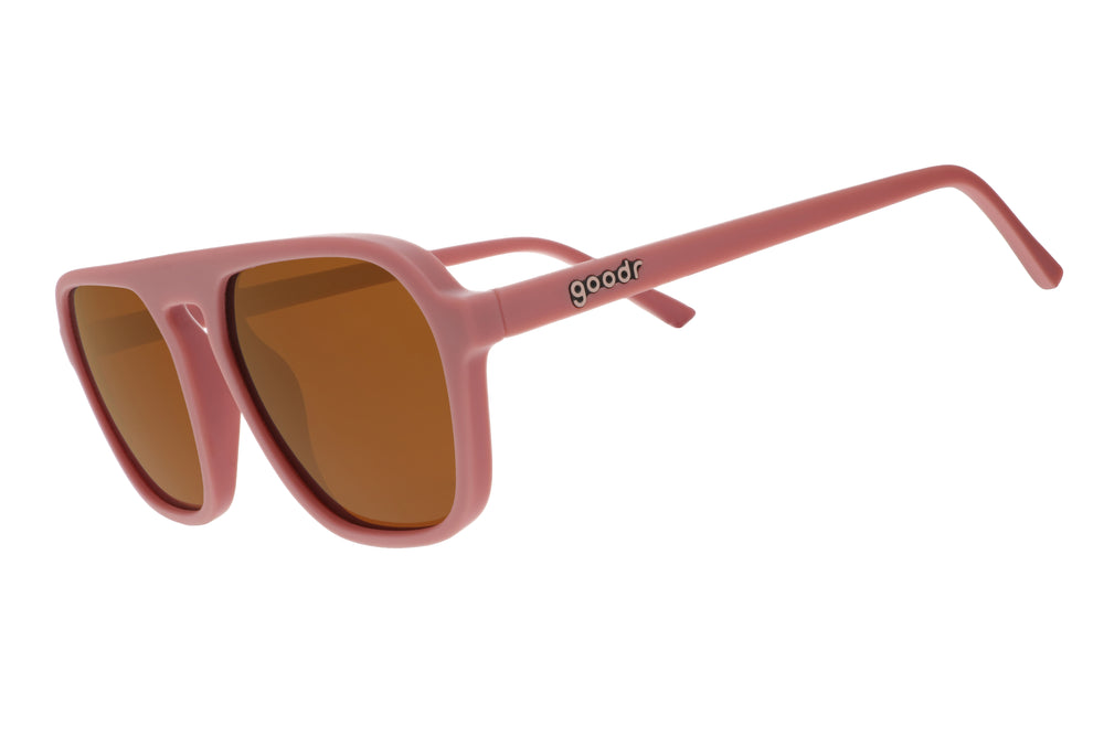Goodr Retro G sunglasses Threaten Me With a Good Time featuring light pink vintage-inspired square aviator frames with brown non-reflective lenses, designed to stay secure without slipping or bouncing
