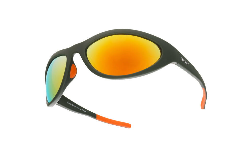 goodr Bug G Grass Stain Hall of Fame sunglasses with green wrap-around frame and amber mirrored lenses, designed with no-slip, no-bounce performance for sports and active lifestyles.