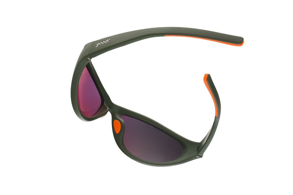 goodr Bug G Grass Stain Hall of Fame sunglasses with green wrap-around frame and amber mirrored lenses, designed with no-slip, no-bounce performance for sports and active lifestyles.