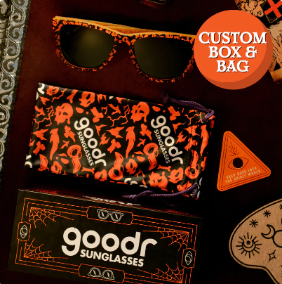 Goodr OG limited edition sunglasses 'EXERCISE THE DEMONS!!!' – Halloween-inspired orange and black pattern sunglasses with polarized dark lenses, lightweight no-slip frame designed for running, workouts, and spooky fun.