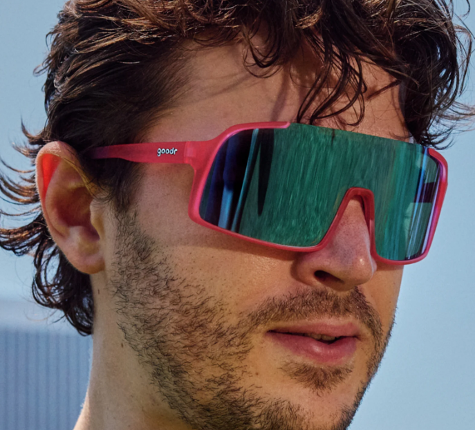 Goodr Shield Astro G sunglasses in Ready the Confetti Canon style with pink frame and blue gradient lenses, perfect for sporty and stylish outdoor wear.