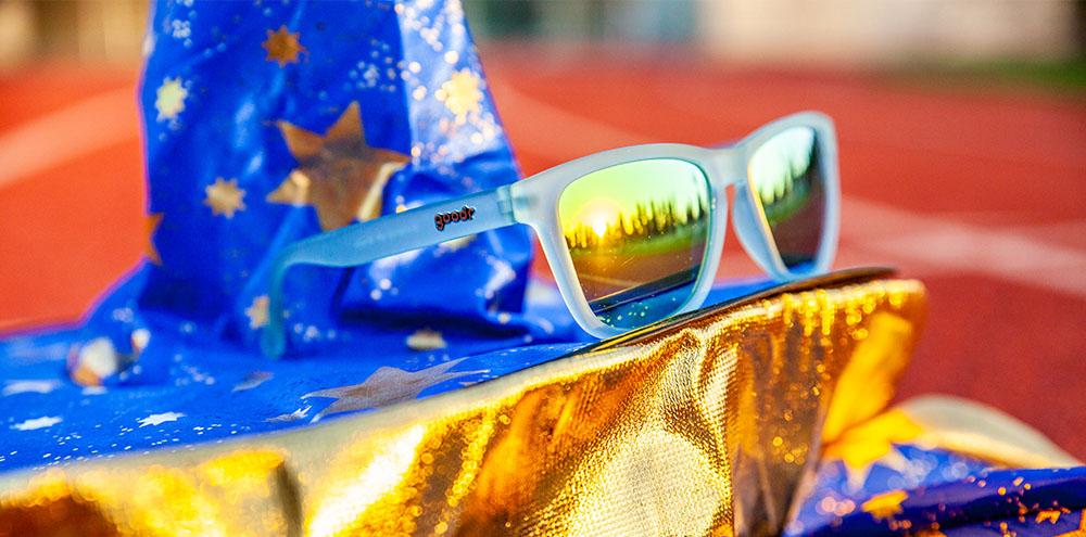Goodr Sunbathing with Wizards OG running sunglasses with fresh blue frame and gold polarized UV400 lenses — perfect no-slip, no-bounce sunglasses for running and everyday wear.