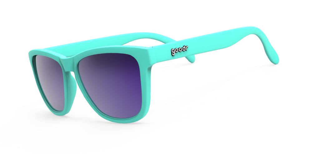 Goodr Electric Dinotopia Carnival OG running sunglasses with vibrant pink and purple frame, polarized UV400 lenses, and no-slip, no-bounce design — ideal for running and active lifestyles.