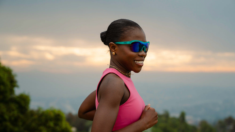 Runner wearing goodr Sonic G Cue Slow-Mo Montage running sunglasses teal frame mirrored lens outdoor training
