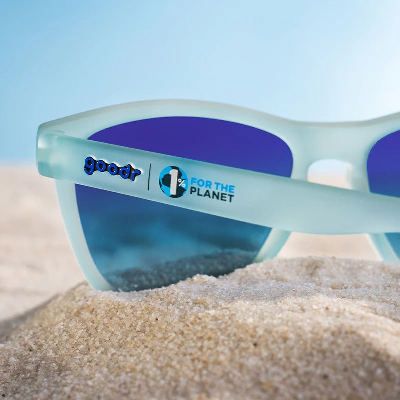 “goodr These Shades Are Still Trash sunglasses with frosted translucent frame and blue mirrored lenses made from recycled materials.”